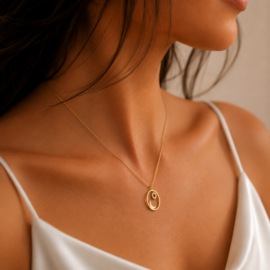 Woman wearing a Sun and Moon Necklace in solid 18K yellow gold with a white satin dress.