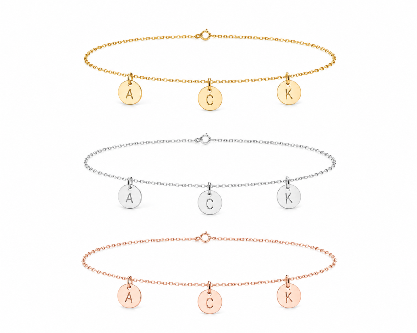 Three delicate initial necklaces with round engraved disc charms are shown on a plain white background. The top necklace is gold-tone with letters A, C, and K.