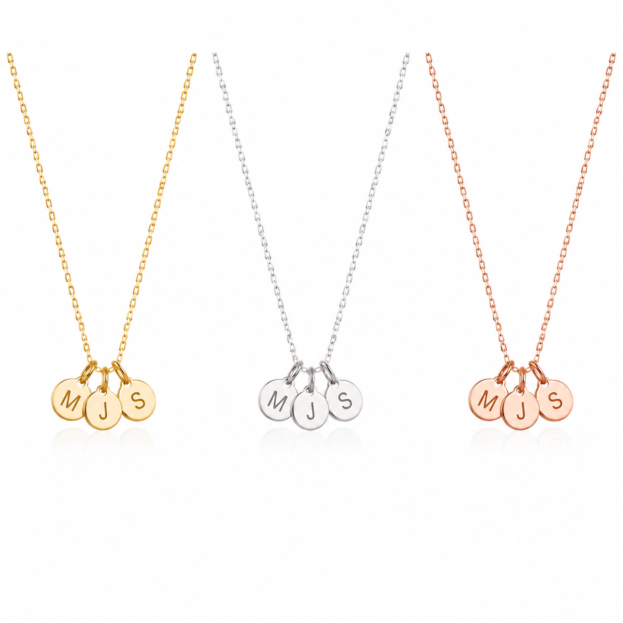 Three personalized initial necklaces with round engraved disc charms spelling 'MJS' and 'MJS S', shown in yellow gold, silver, and rose gold on a white background.