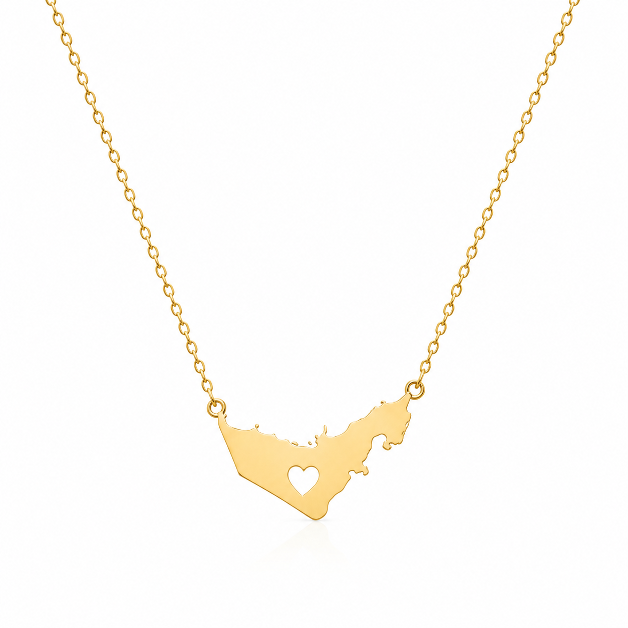 A gold chain necklace featuring a UAE map shaped polished gold pendant with a small heart cutout in the center, shown against a plain white background.