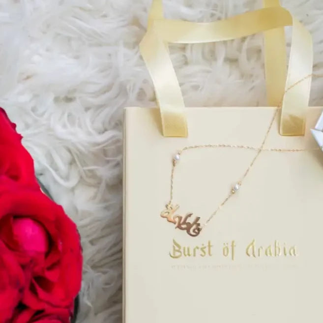 Simple yet eye-catching, this gold Arabic name necklace with birthstone is a stylish look anyone will appreciate. Our Name Necklace is a great piece that follows the fashion trend! Its fine curves and magnificent lettering make it a truly enjoyable necklace for you and your loved ones.   Made in Dubai, UAE.