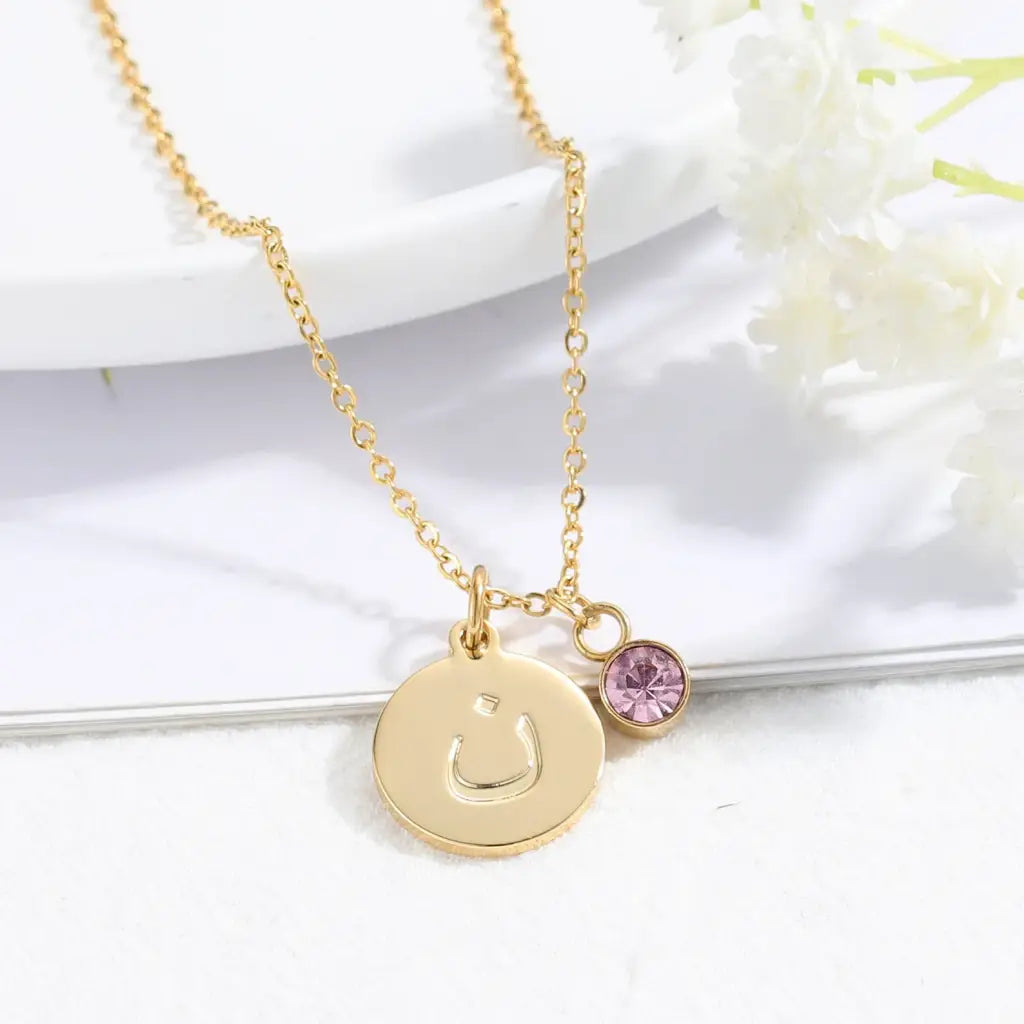 Arabic letter coin initial Necklace with birthstone Designed and handcrafted in the UAE. Delivers within 1 to 3 business days. This classic Arabic gold name necklace is locally handcrafted with the highest quality materials and artisans available in Dubai. The perfect gift to put a smile on her face. Anniversary, birthday, and luxury gifts for women.
