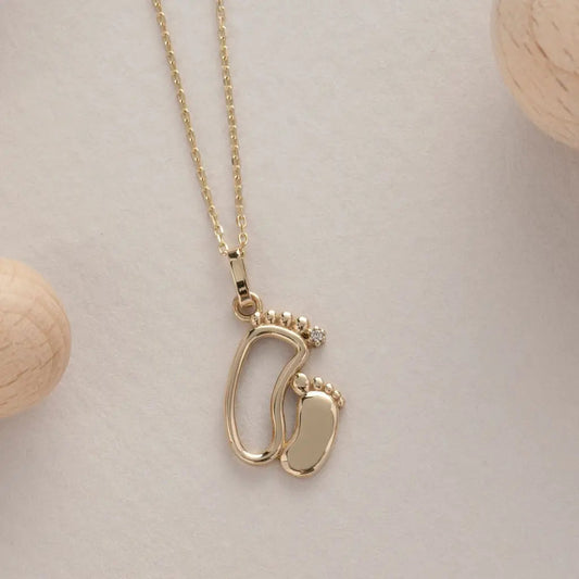 18K Gold Personalized Baby Feet Necklace Designed and handcrafted in the UAE.
