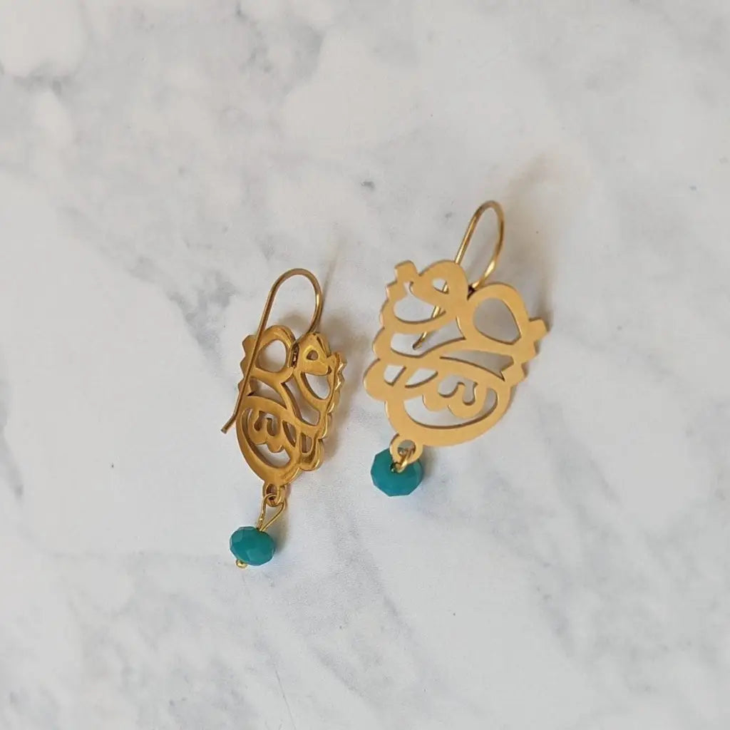Arabian calligraphy earrings made in real gold. Designed and handcrafted in the UAE. These gorgeous authentic calligraphy earrings are locally handcrafted with the highest quality materials and artisans available in Dubai.