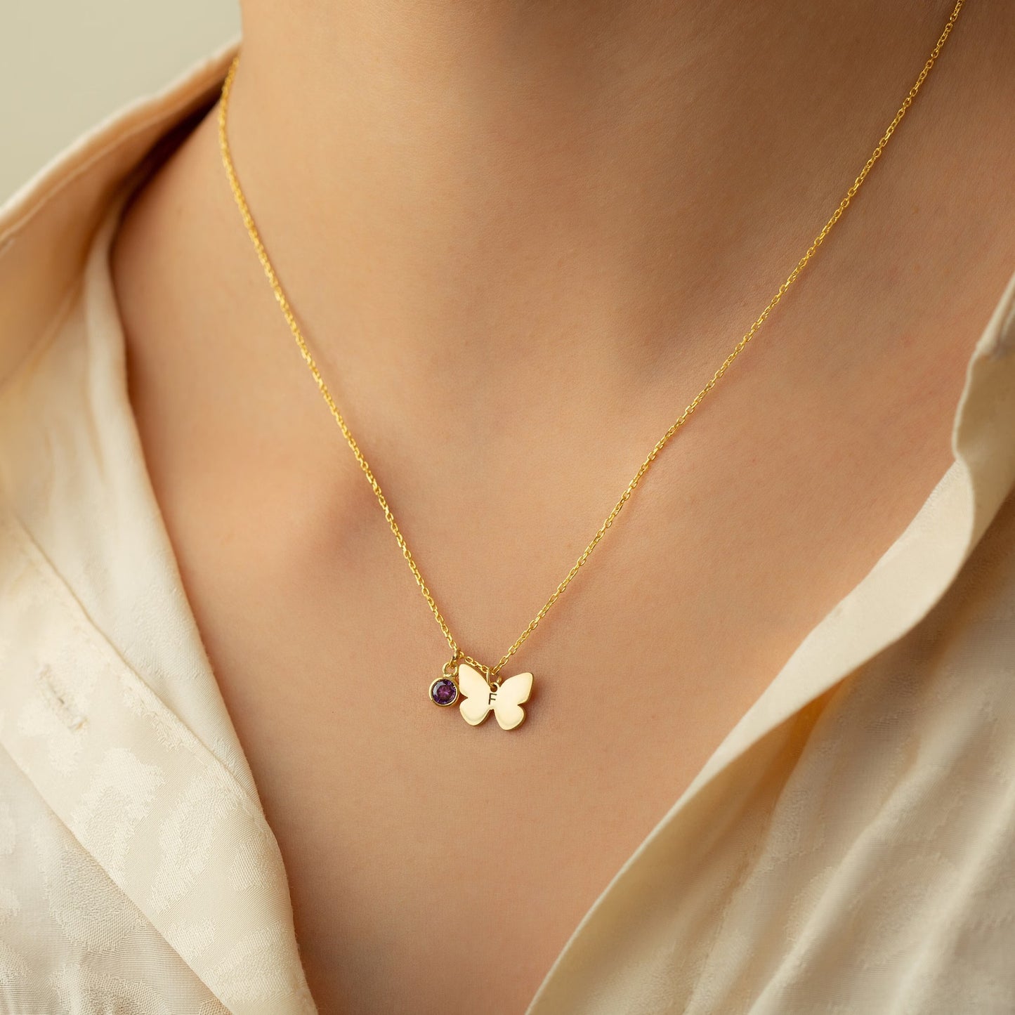 Personalized Gold Butterfly Initial Birthstone Necklace Designed and handcrafted in the UAE.  Pamper your loved one with this exquisite 18 carat gold butterfly initial birthstone necklace, complete with a delicate gold butterfly, birthstone and the initial of your choice.