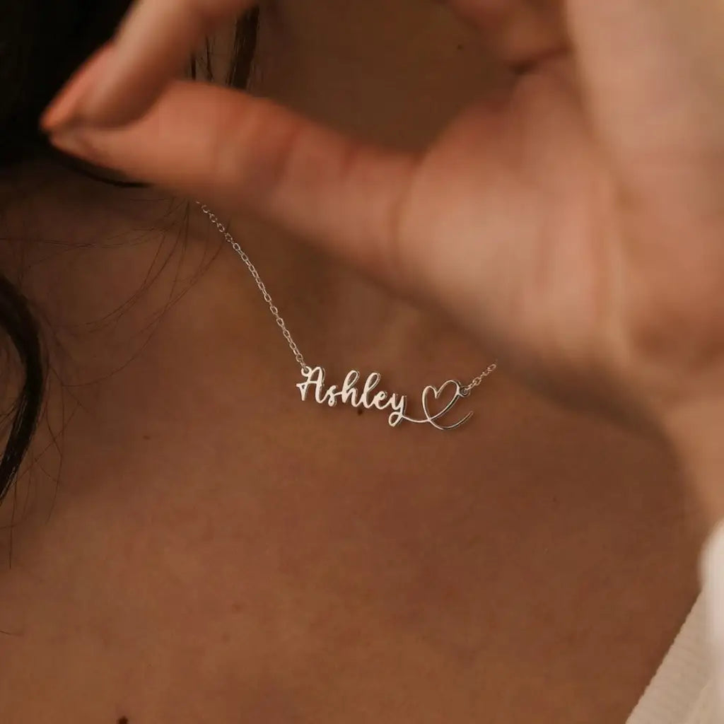 This gold heart name necklace is a stylish look anyone will appreciate. Whether you’re treating yourself or hunting for a unique, priceless and luxurious anniversary or birthday gift, our gold jewelry collections allow you to wonderfully express what's in your heart. Handcrafted in Dubai, United Arab Emirates.
