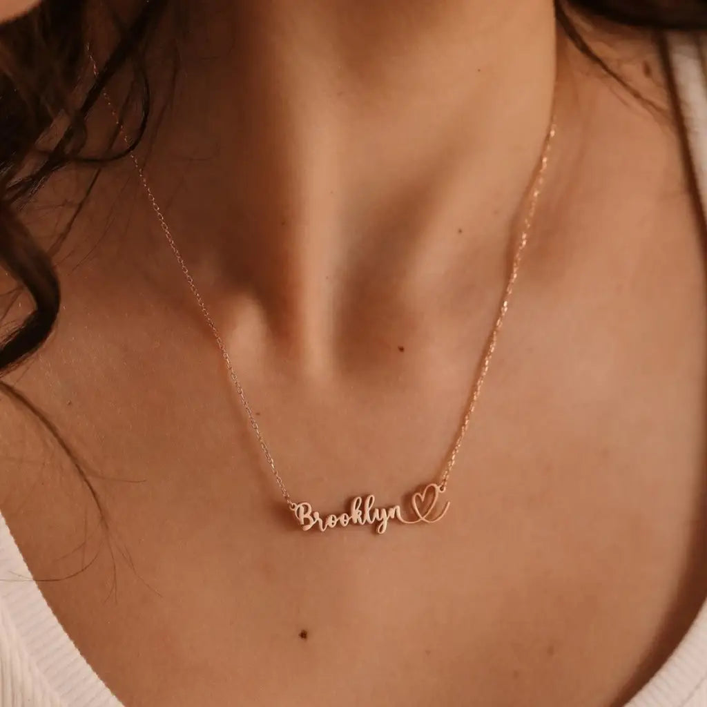 This gold heart name necklace is a stylish look anyone will appreciate. Whether you’re treating yourself or hunting for a unique, priceless and luxurious anniversary or birthday gift, our gold jewelry collections allow you to wonderfully express what's in your heart. Handcrafted in Dubai, United Arab Emirates.