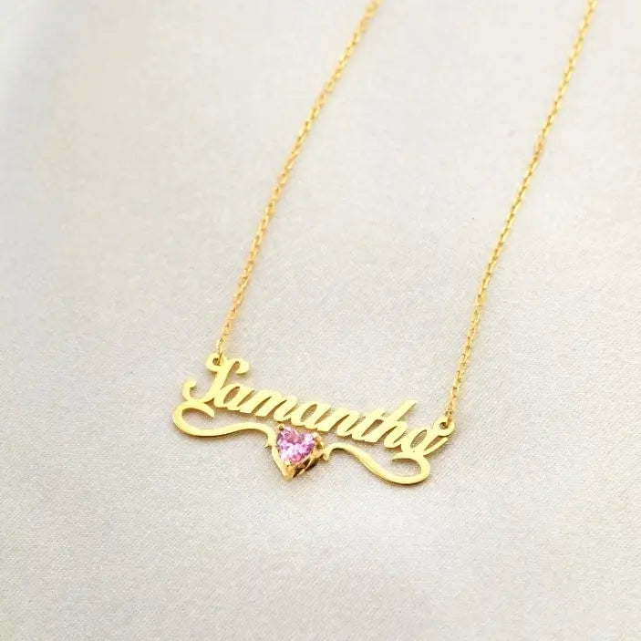 Gold Heart-shaped Birthstone Necklace - available in gold. Made in real gold, this birthstone heart-shaped name necklace is locally handcrafted with the highest quality materials and artisans available in Dubai.  Great addition to your jewelry collection and is also the ideal gift for a loved one.