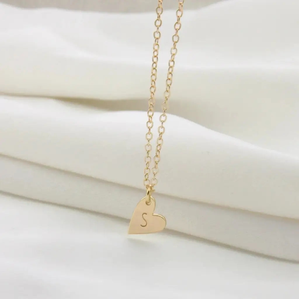 Gold Heart-shaped Initial Necklace Personalized, designed and handcrafted in the UAE. This fine and minimal heart initial necklace is locally handcrafted with the highest quality materials and artisans available in Dubai. 