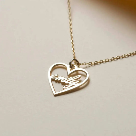 18k Gold Heart-shaped Necklace. Made in genuine gold, this heart-shaped name necklace will add a touch of luxury to any outfit whether you're treating yourself or looking for a meaningful gift for that special someone.