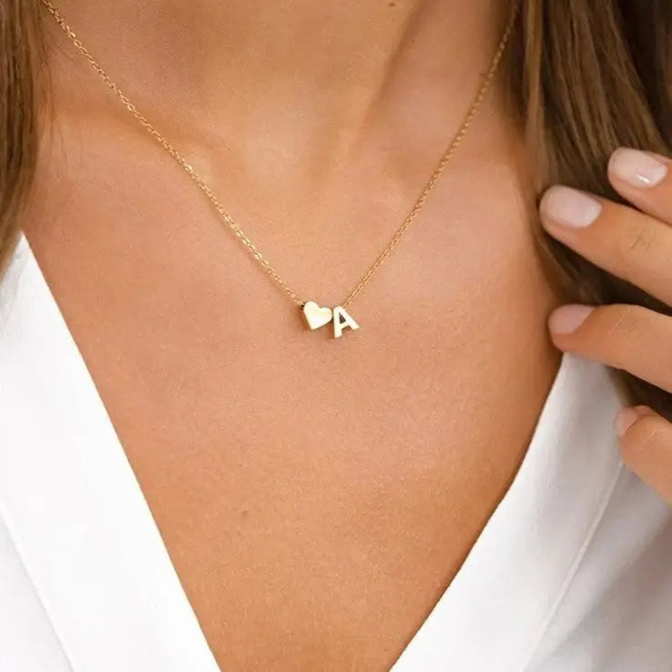 Gold Heart Letter Initial Necklace Personalized, designed and handcrafted in the UAE. Delivers within 2 to 5 business days.  This fine and minimal sideways initial necklace is locally handcrafted with the highest quality materials and artisans available in Dubai. 