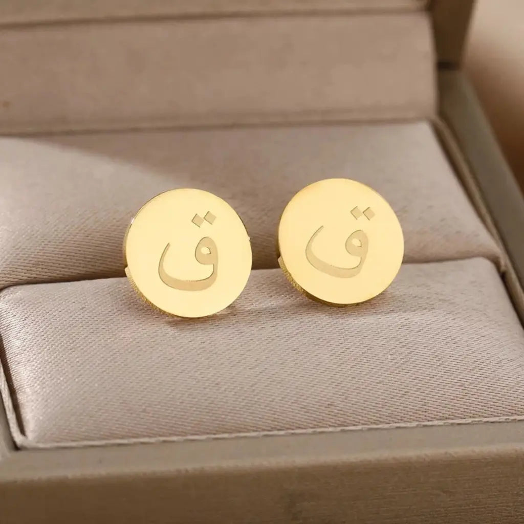 Express your unique style with these Arabian authentic earrings. The earrings are made of real gold and the initials are beautifully placed in the center of the gold circle frame to form a unique charming pattern. These classic earrings are sure to garner all the attention.   Designed in the United Arab Emirates.