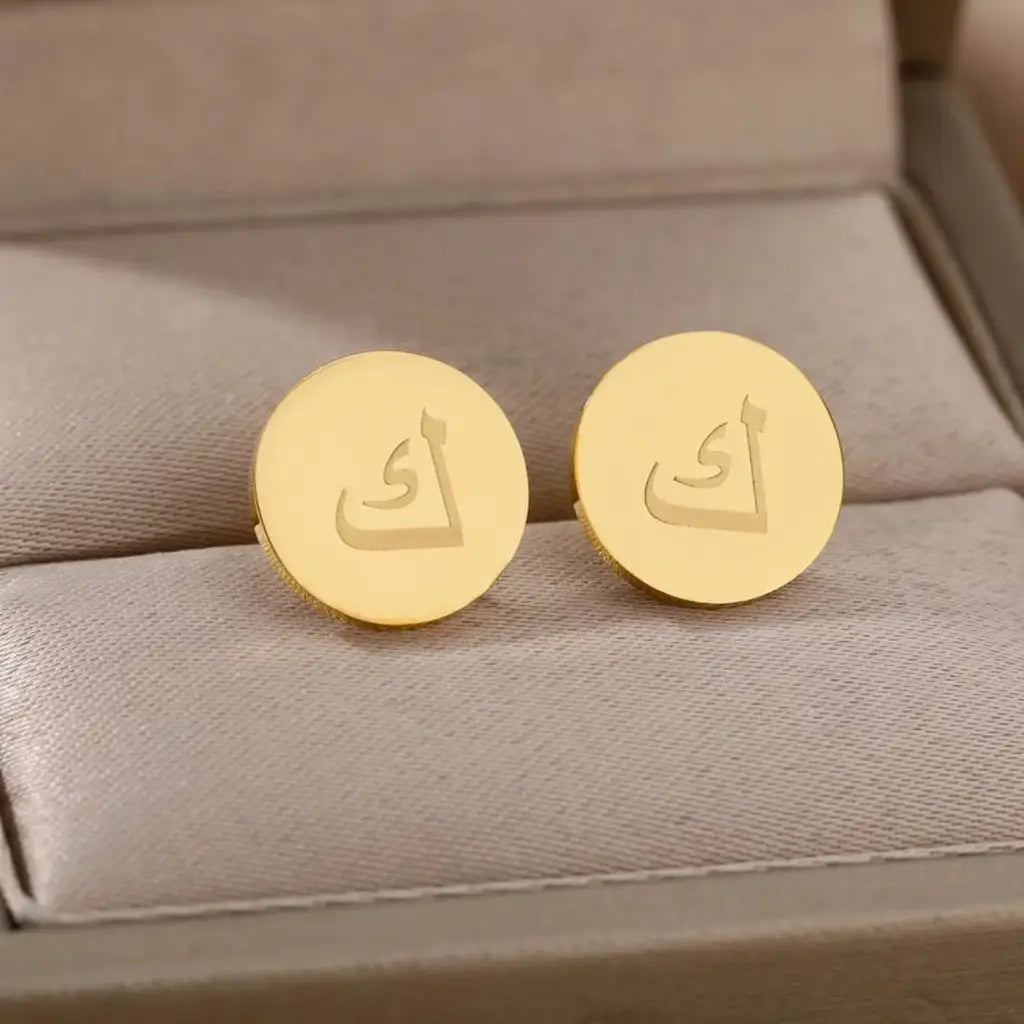 Express your unique style with these Arabian authentic earrings. The earrings are made of real gold and the initials are beautifully placed in the center of the gold circle frame to form a unique charming pattern. These classic earrings are sure to garner all the attention.   Designed in the United Arab Emirates.