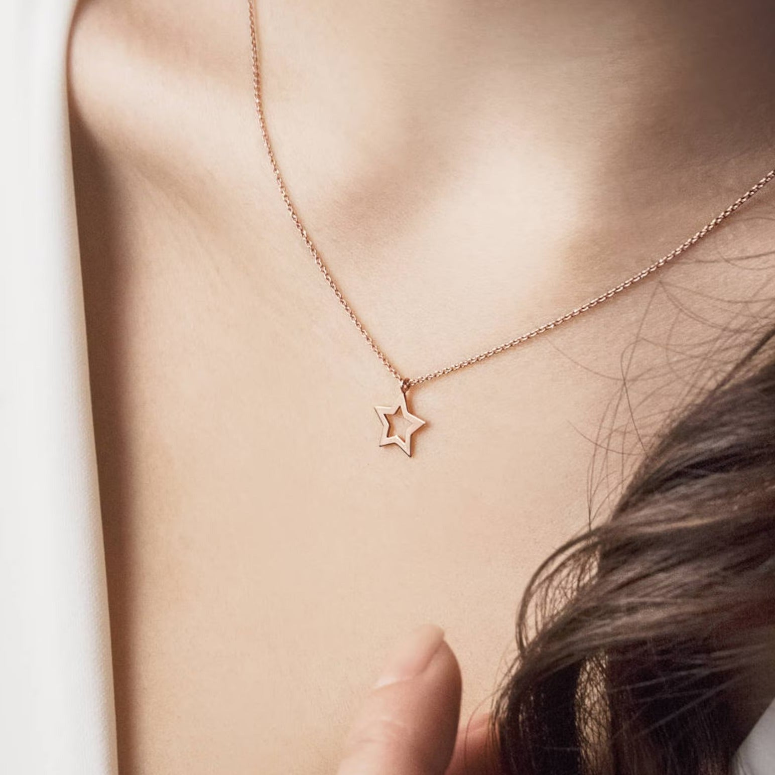 Indulge in the celestial charm of our 18 Carat Gold Tiny Star Necklace - Burst of Arabia. A radiant tribute to Arabian nights, adorned with miniature stars in pure gold.