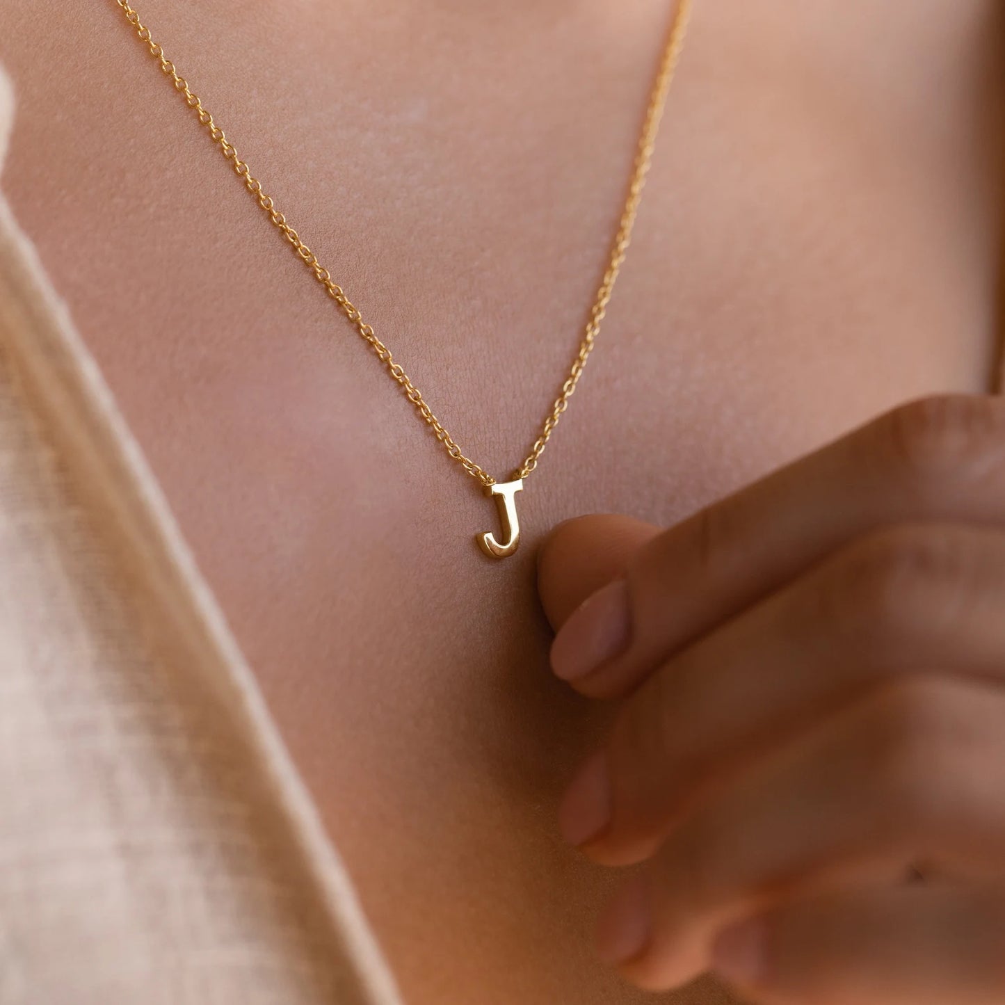 Gold initial necklace featuring exquisite craftsmanship, perfect for adding a touch of personalized elegance to your style.