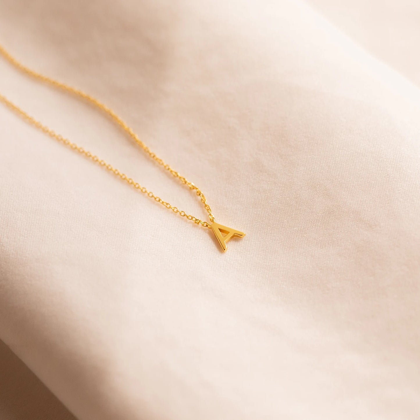 Gold initial necklace featuring exquisite craftsmanship, perfect for adding a touch of personalized elegance to your style.