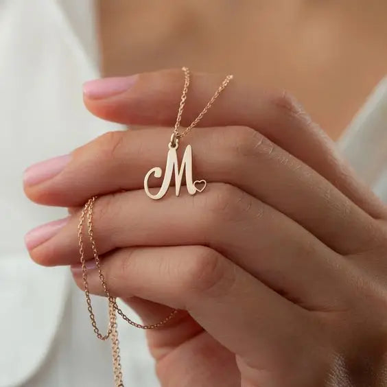 Gold initial letter heart necklace - made in real solid gold. The perfect gift for your loved ones and is also great for layering with other necklaces or minimalist wear. Can be personalized in Arabic or English. Crafted to the highest standards and is made at our jewelry workshop in Dubai at the United Arab Emirates.