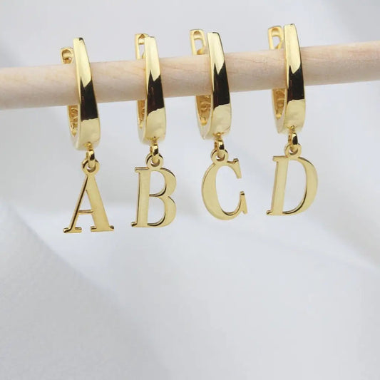 Personalized Initial Letter Hoop Earrings. Designed and handcrafted in the UAE. These gold alphabet initial earrings are locally handcrafted with the highest quality materials and artisans available in Dubai. 