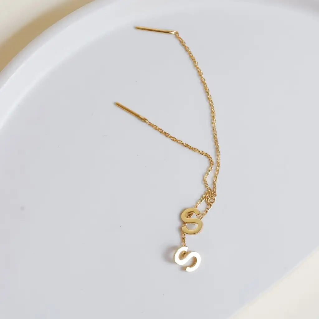 This pair of gold initial earrings is locally handcrafted with the highest quality materials and artisans available in Dubai.  Our jewelry is locally handcrafted with the highest quality materials and artisans available in Dubai. 