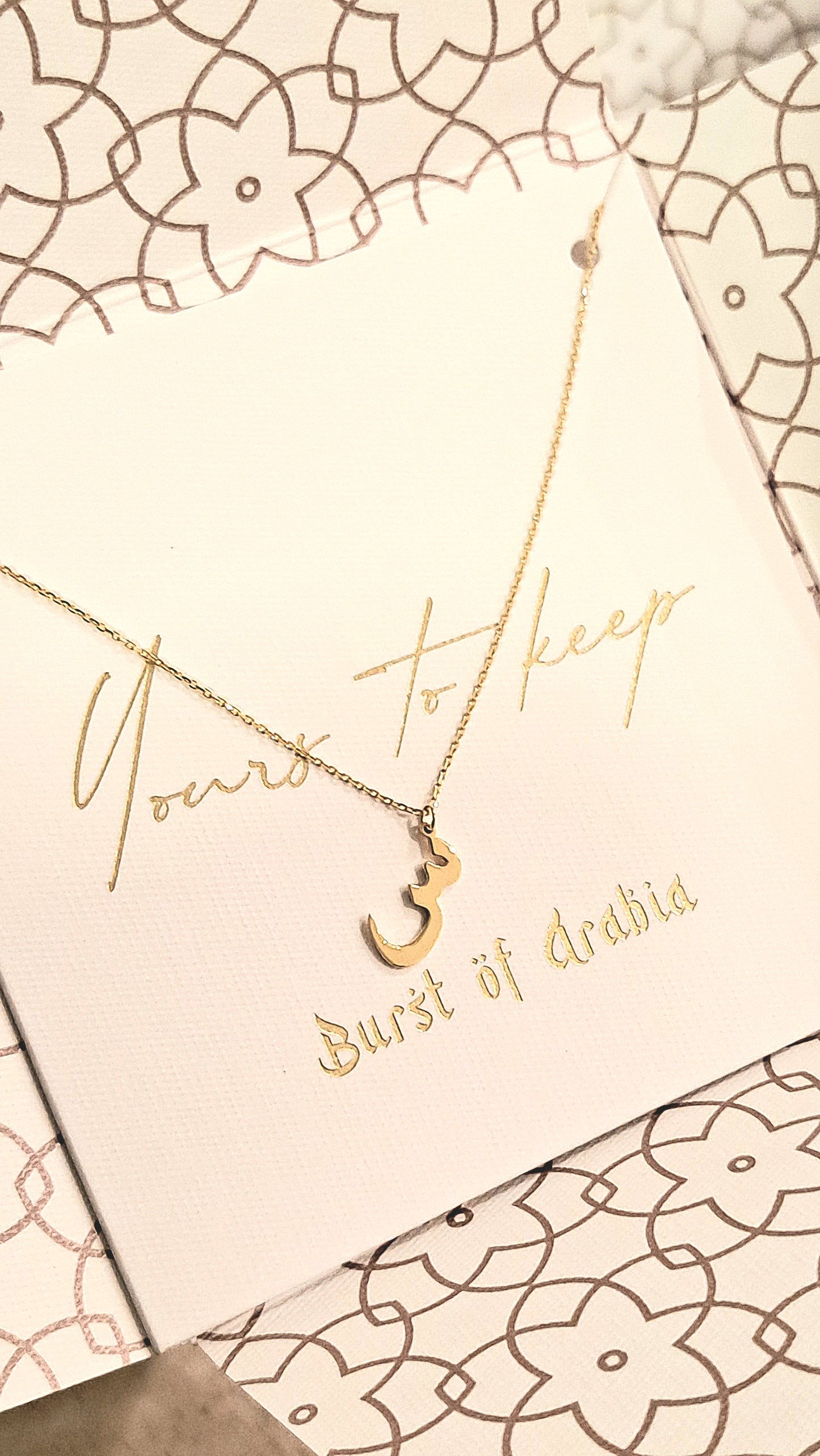 Arabic letter necklace designed in 18 carat gold.