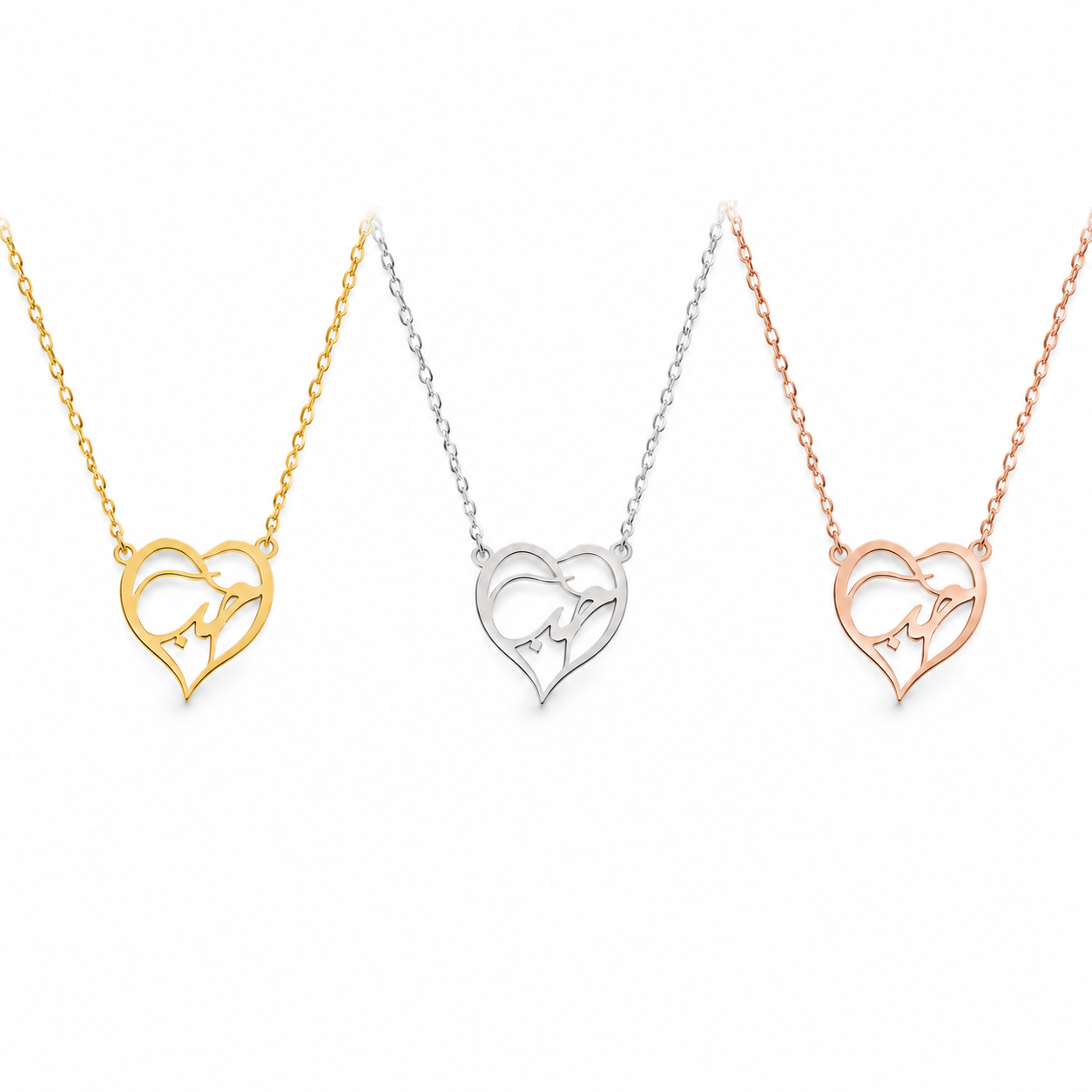 Three heart-shaped interlocking necklaces shown on a white background, in yellow gold, silver, and rose gold finishes.