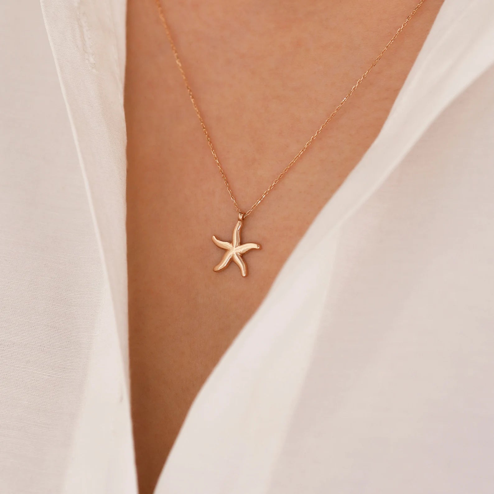 Close-up view of 18 Carat Gold Starfish Necklace from Burst of Arabia, showcasing exquisite craftsmanship and intricate detailing, perfect for adding a touch of elegance to your style.