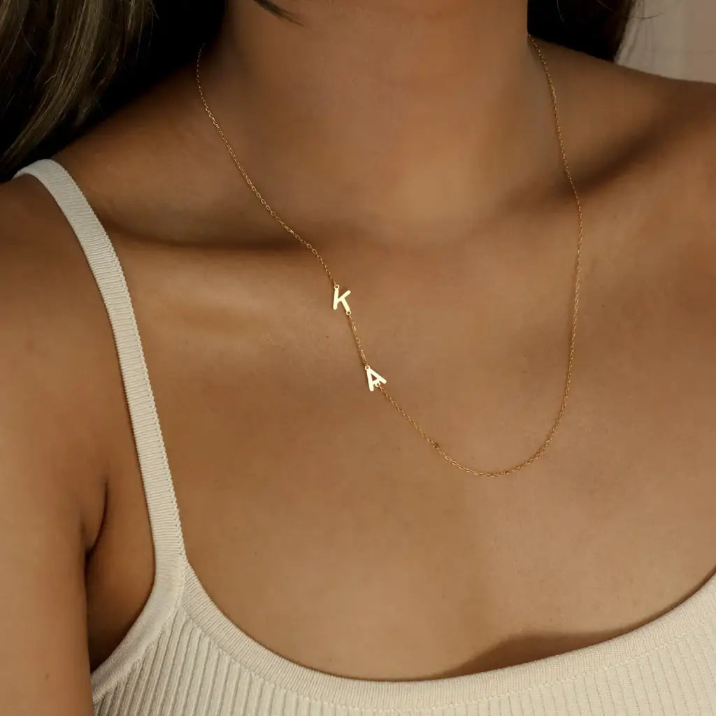 Trendy and elegant, this minimal gold alphabet pendant has a playful charm. This gold necklace is attached to a fine chain made of genuine solid gold and personalized with the initials of your choice. A great addition to your jewelry collection and a thoughtful gift for the loved ones.  Designed in Dubai.