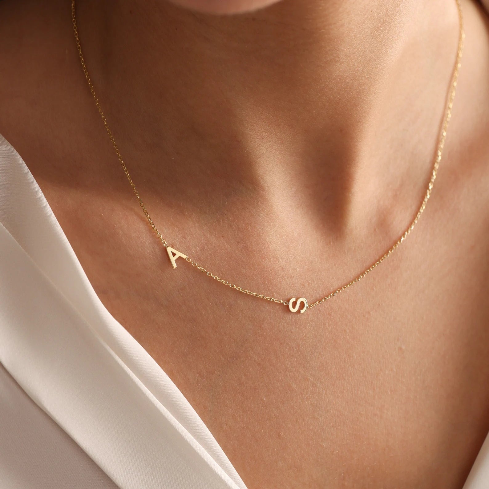 Trendy and elegant, this minimal gold alphabet pendant has a playful charm. This gold necklace is attached to a fine chain made of genuine solid gold and personalized with the initials of your choice. A great addition to your jewelry collection and a thoughtful gift for the loved ones.  Designed in Dubai.