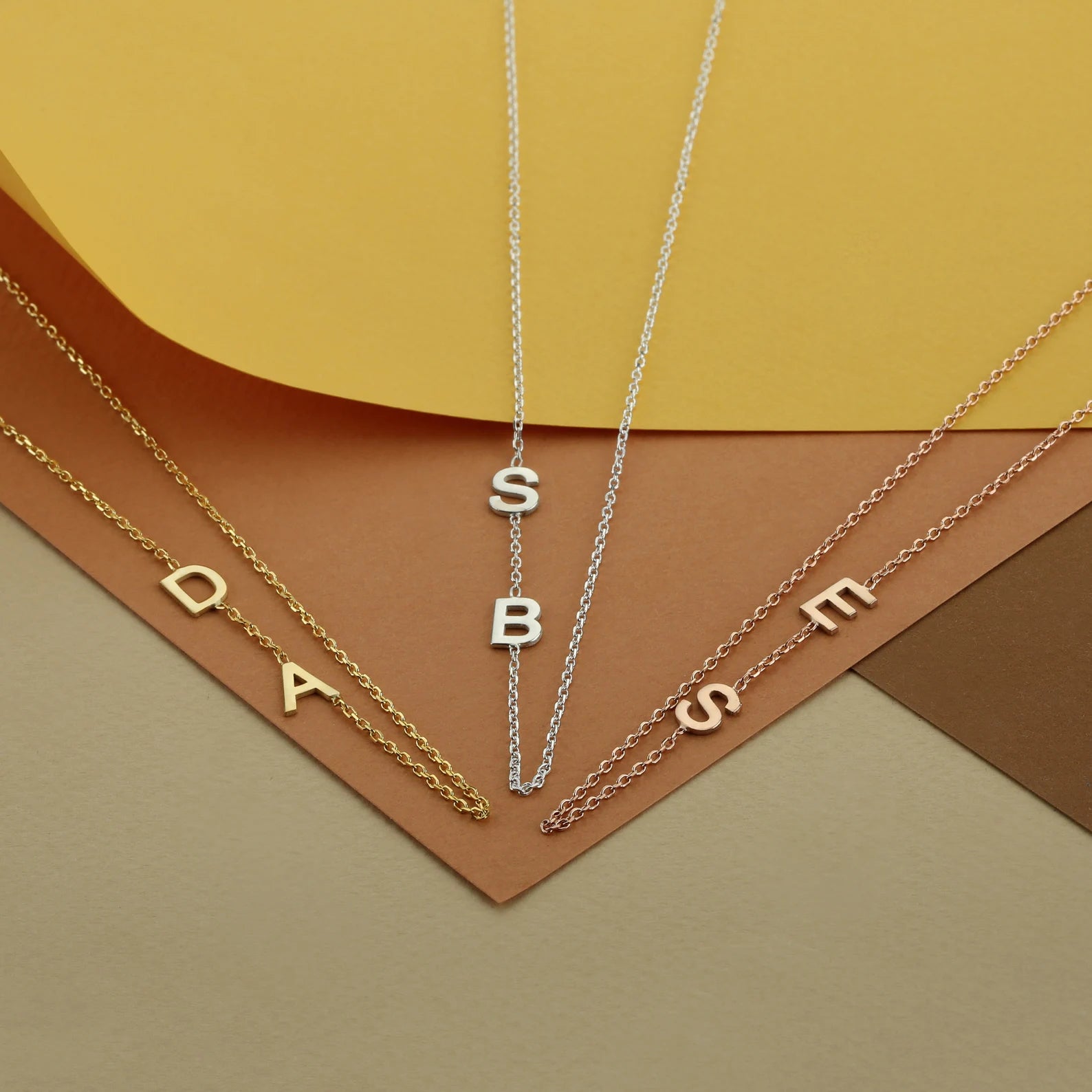 Trendy and elegant, this minimal gold alphabet pendant has a playful charm. This gold necklace is attached to a fine chain made of genuine solid gold and personalized with the initials of your choice. A great addition to your jewelry collection and a thoughtful gift for the loved ones. Designed in Dubai.