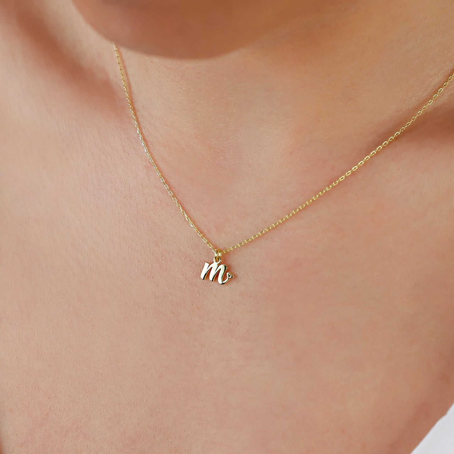 small cap letter initial necklace in yellow gold