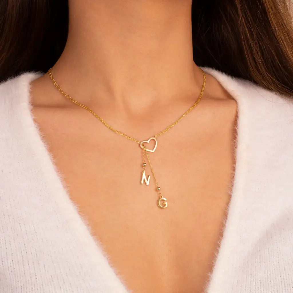 Trendy and elegant, this minimal gold alphabet pendant has a playful charm. This gold necklace is attached to a fine chain made of genuine solid gold and personalized with the initials of your choice. A great addition to your jewelry collection and a thoughtful gift for the loved ones.  Designed in Dubai.